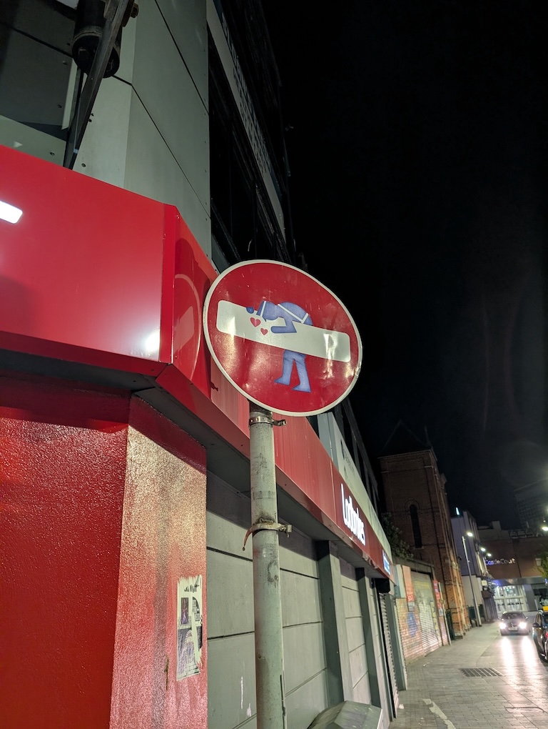 A graffitied no entry sign.