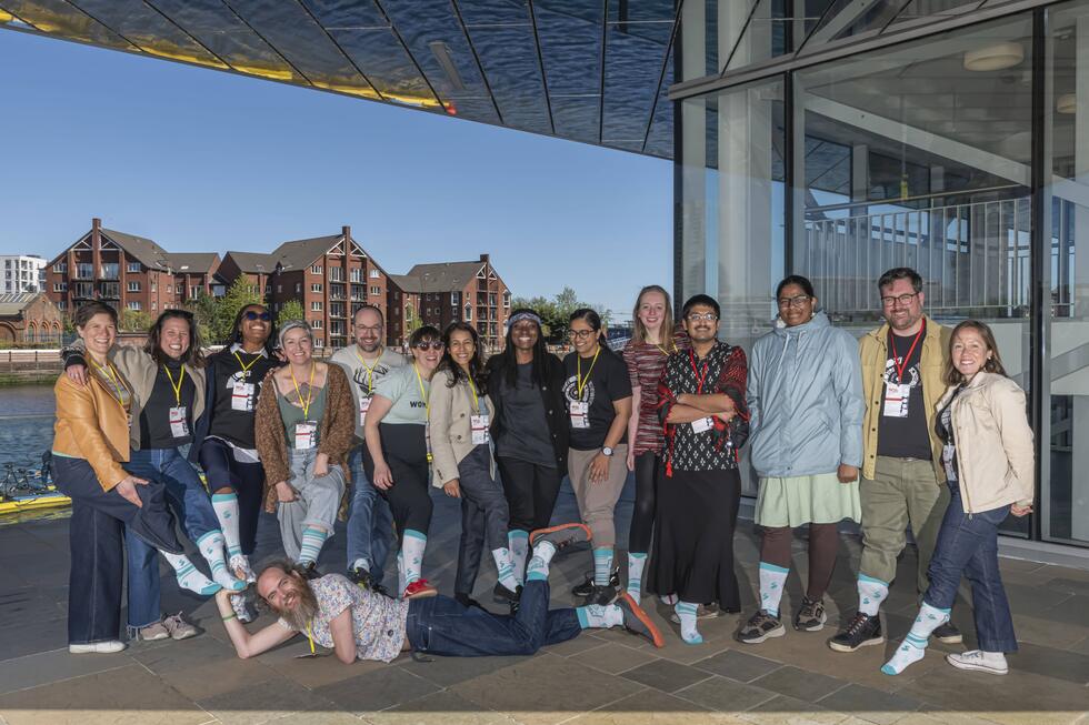SSI / Collaboration Workshop. The Turing Way family posing with TTW socks