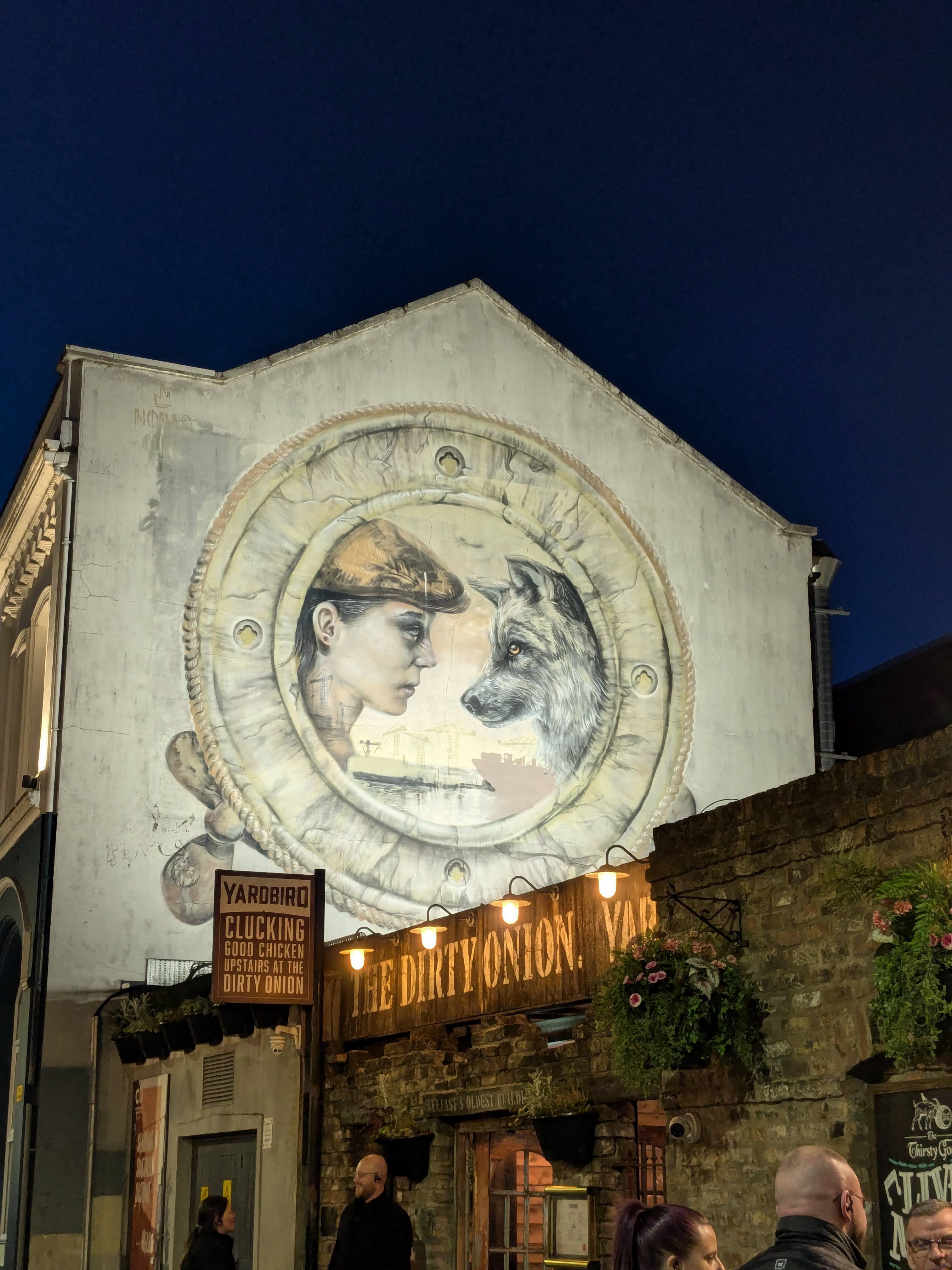 A mural of a woman and a dog.